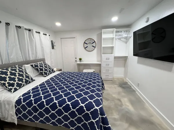 a bedroom with a bed and a television