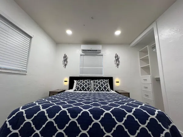 a bedroom with a large bed and a window