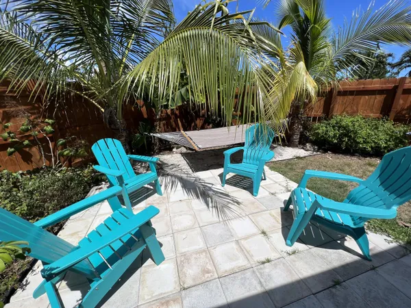 a view of backyard with swimming pool and outdoor seating