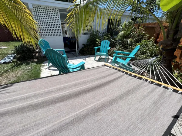 a view of backyard with swimming pool and outdoor seating
