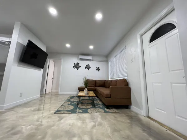 a living room with furniture and a flat screen tv