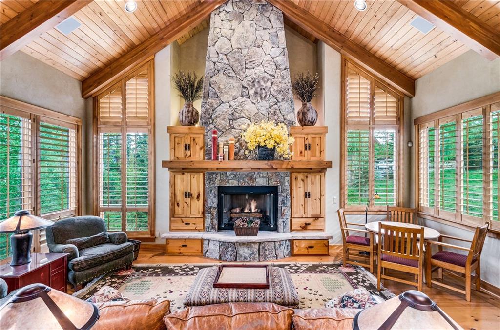 1025 4 O Clock Road Breckenridge, CO 80424 - Photo 2 of 25 a living room with furniture fireplace and large windows