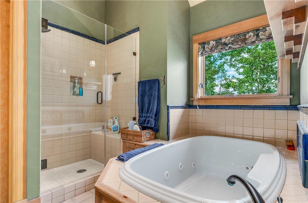 1025 4 O Clock Road Breckenridge, CO 80424 - Photo 14 of 25 a bathroom with a tub and a shower