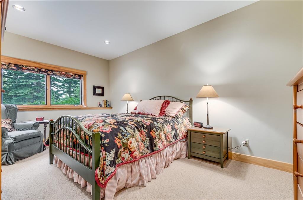 1025 4 O Clock Road Breckenridge, CO 80424 - Photo 21 of 25 a bed sitting in a bedroom next to a window