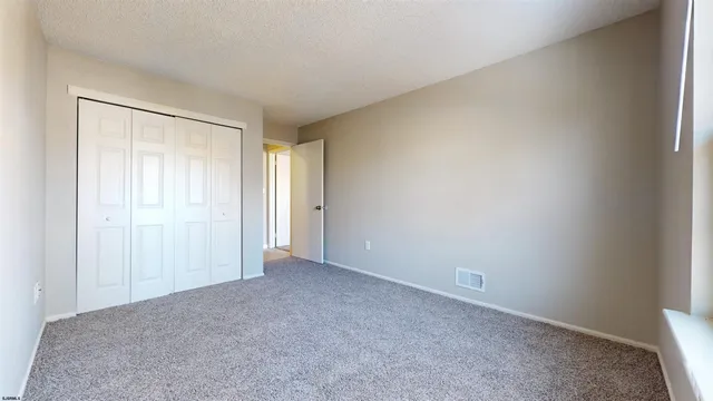 a view of an empty room and closet area