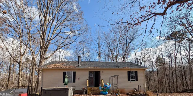 a view of a house with a large tree