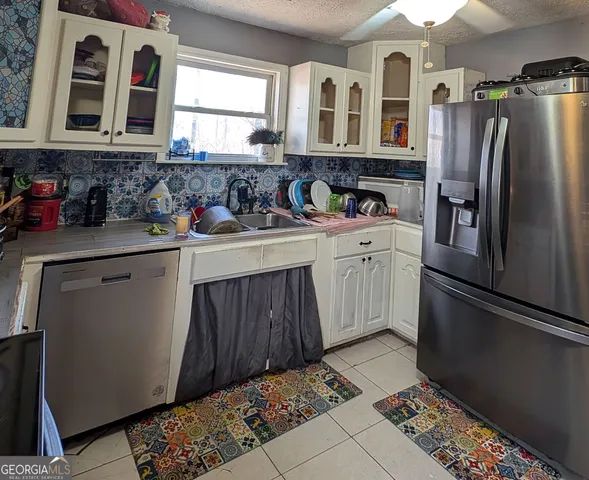 a kitchen with stainless steel appliances granite countertop a stove and a refrigerator