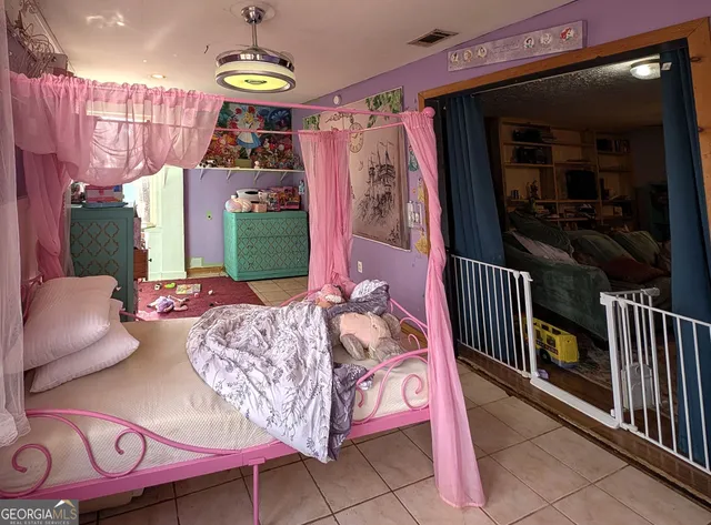 a bed sitting in a bedroom next to a window