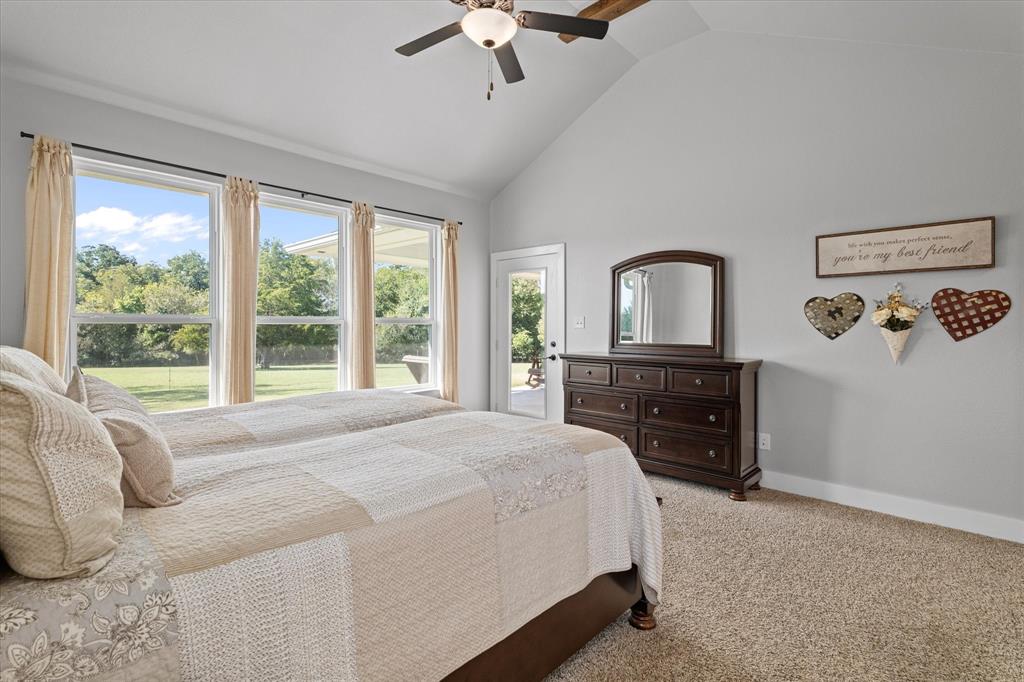 725 Wilson Road Van Alstyne, TX 75495 - Photo 14 of 40 a bedroom with a bed and a dresser next to a window