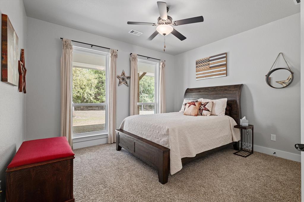 725 Wilson Road Van Alstyne, TX 75495 - Photo 18 of 40 a bedroom with a bed and a window
