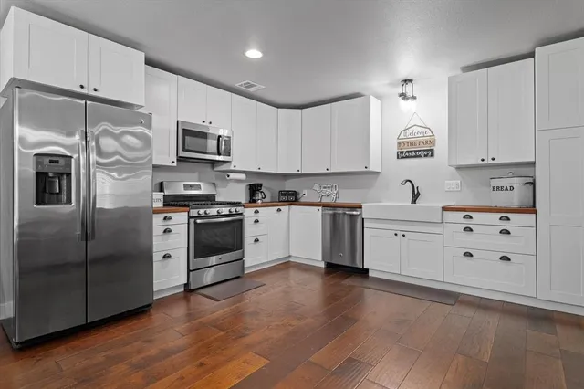 a kitchen with stainless steel appliances and white cabinets