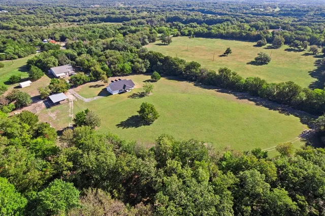 an aerial view of a house with a yard