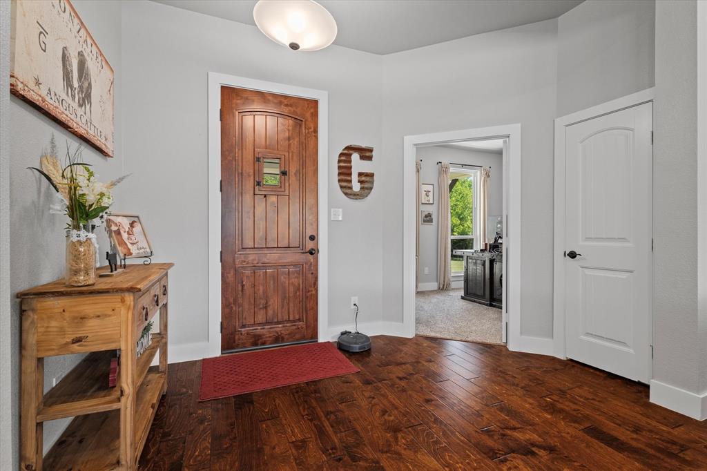 725 Wilson Road Van Alstyne, TX 75495 - Photo 6 of 40 a bedroom with a bed and a wooden floor