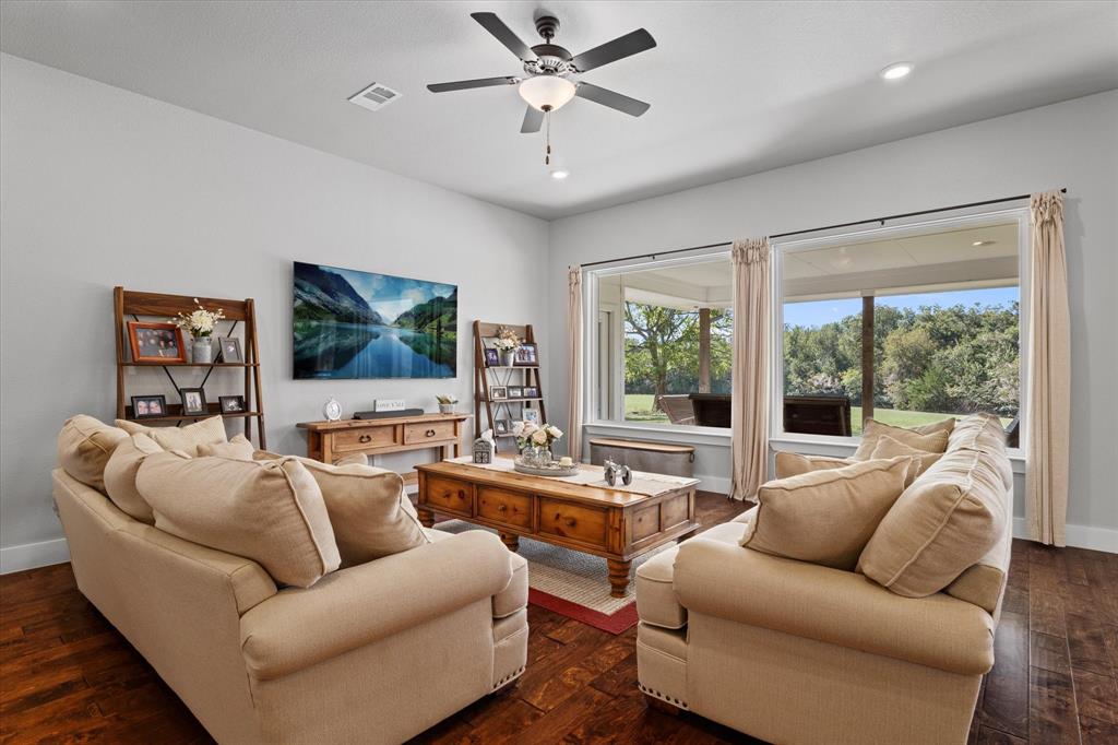 725 Wilson Road Van Alstyne, TX 75495 - Photo 7 of 40 a living room with furniture and a flat screen tv