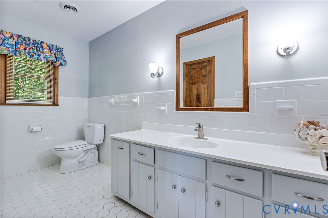 5700 Elfinwood Road Chester, VA 23831 - Photo 25 of 38 a bathroom with a toilet sink and mirror