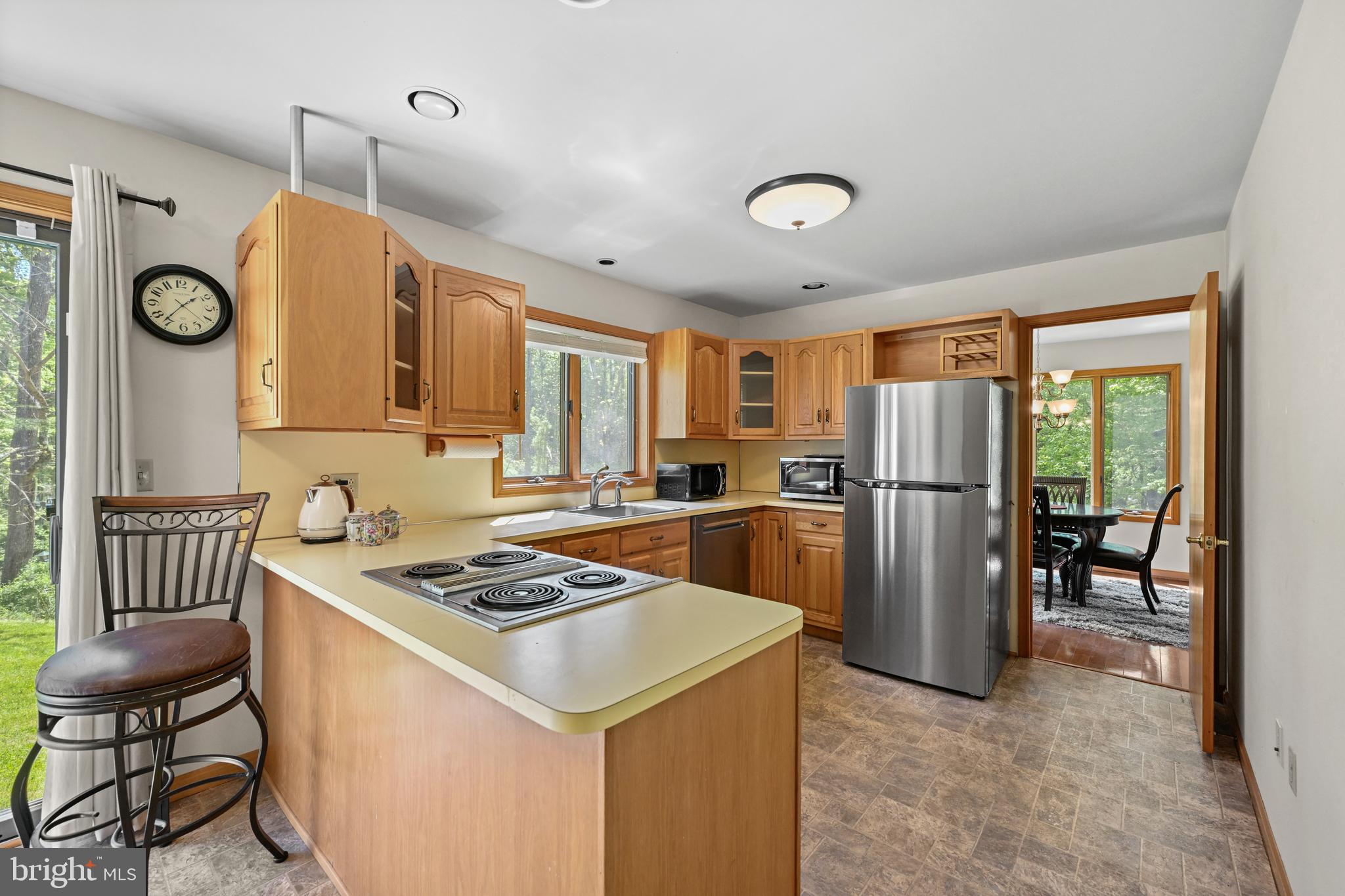 1680 East Street Road Kennett Square, PA 19348 - Photo 10 of 30 a kitchen that has a table chairs a refrigerator and a stove