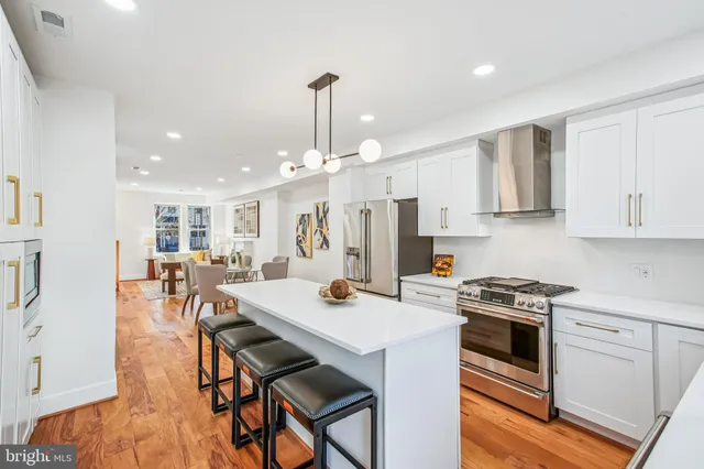 a kitchen with stainless steel appliances granite countertop a stove and a sink