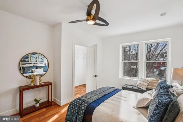 a bathroom with a toilet a sink a mirror and vanity