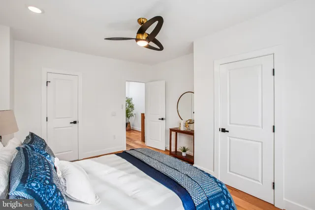 a bedroom with a bed and a painting on the wall