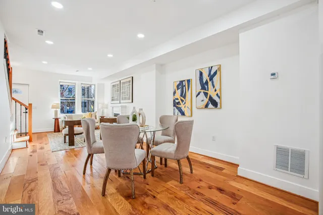 a kitchen with a dining table chairs refrigerator and cabinets