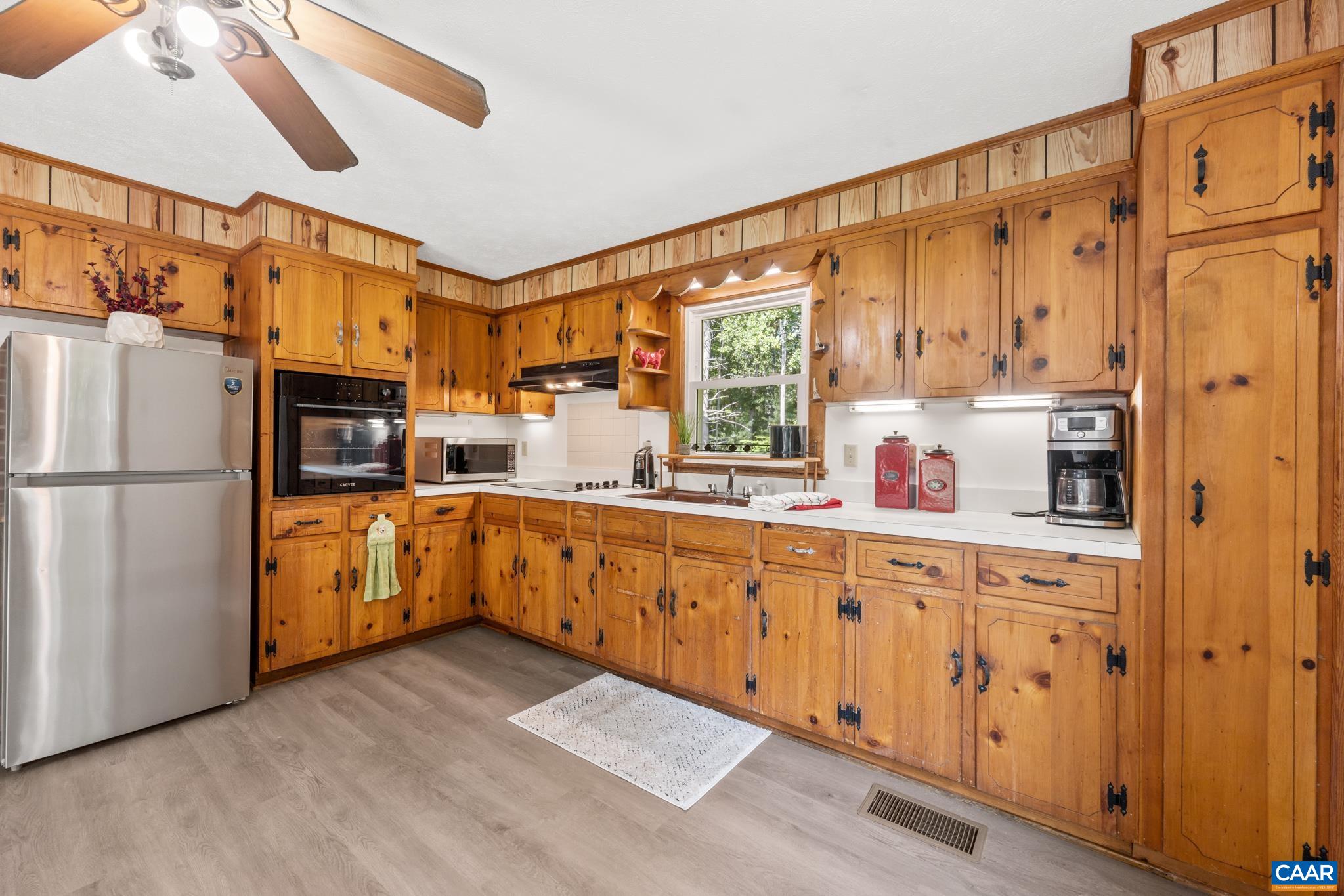 47 Reva Lane Ruckersville, VA 22968 - Photo 13 of 55 The original wood cabinetry brings vintage character and classic charm, while newer luxury vinyl flooring adds a fresh and practical touch.