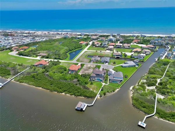 an aerial view of residential houses with outdoor space and street view