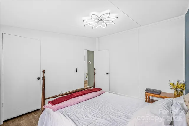 a bedroom with a bed and a chandelier