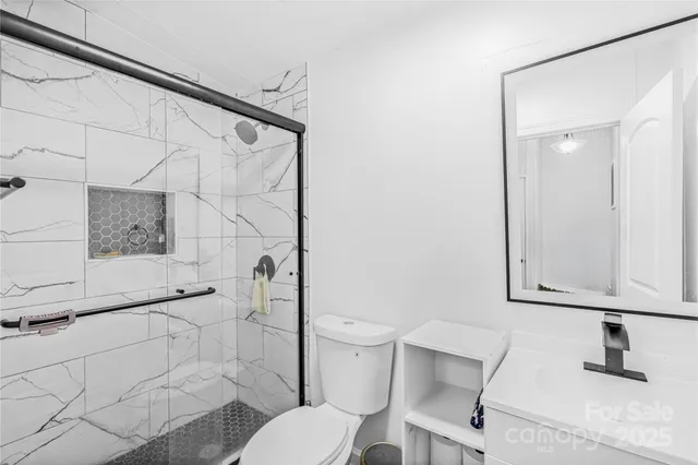 a bathroom with a toilet sink and shower