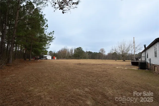 a view of dirt road with a building in the background
