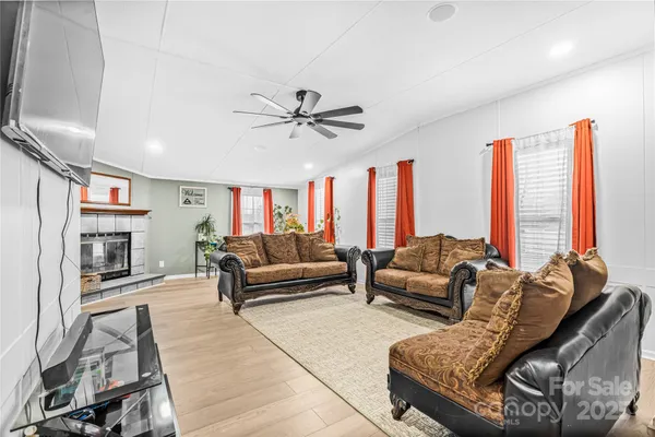 a living room with furniture and a fireplace
