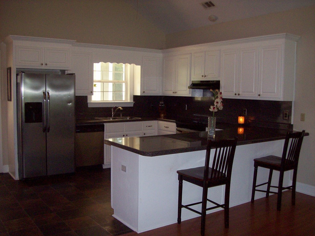 20 Lower Simmons Road Macon, GA 31220 - Photo 3 of 32 a kitchen that has a cabinets and a stove top oven