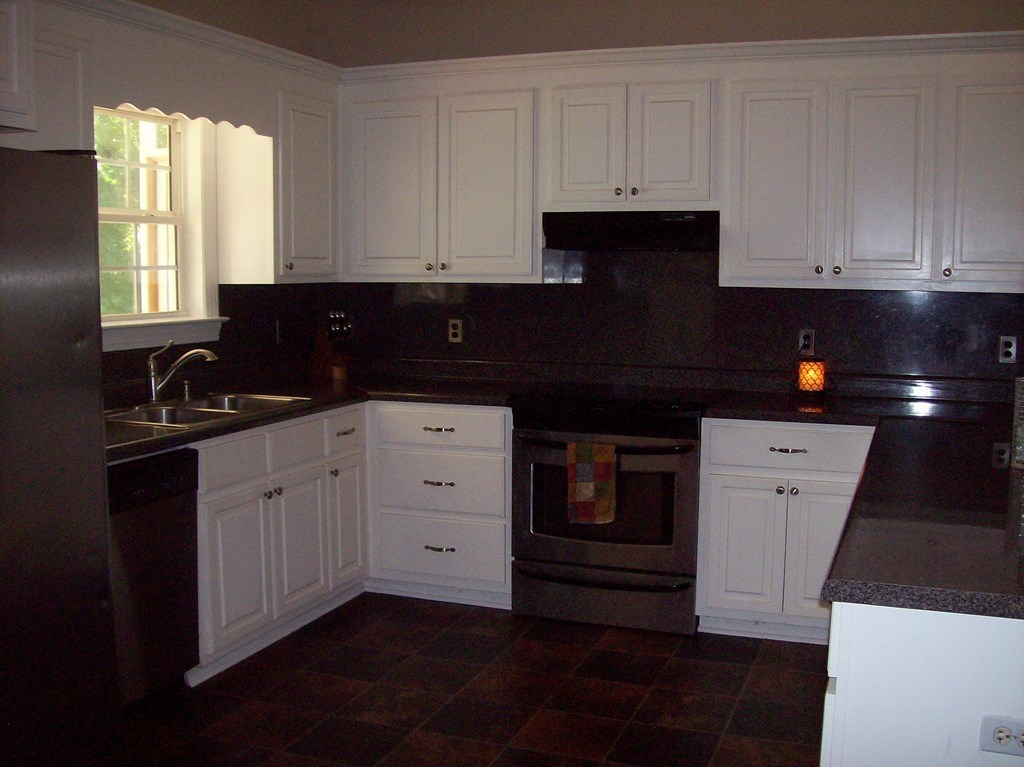 20 Lower Simmons Road Macon, GA 31220 - Photo 4 of 32 a kitchen with white cabinets and sink