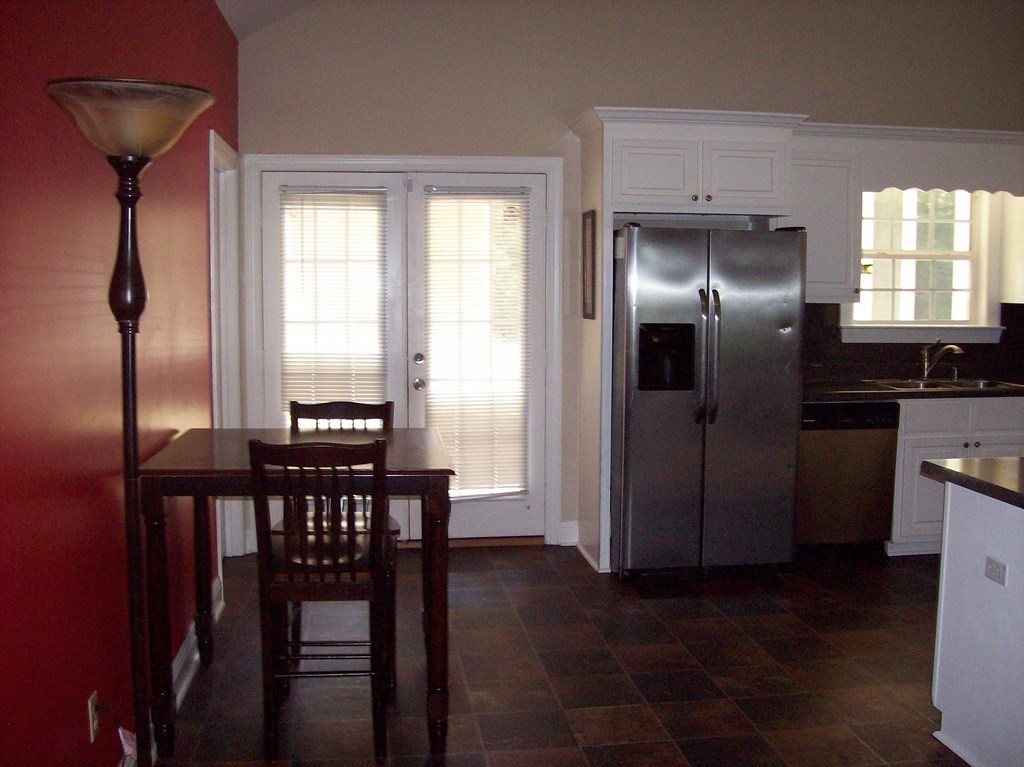 20 Lower Simmons Road Macon, GA 31220 - Photo 6 of 32 a kitchen with stainless steel appliances granite countertop a dining table chairs and granite counter tops