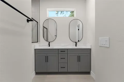 a bathroom with a shower and a sink