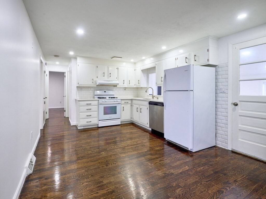 29 Dillon Street Worcester, MA 01604 - Photo 11 of 22 a kitchen with stainless steel appliances a refrigerator sink and cabinets