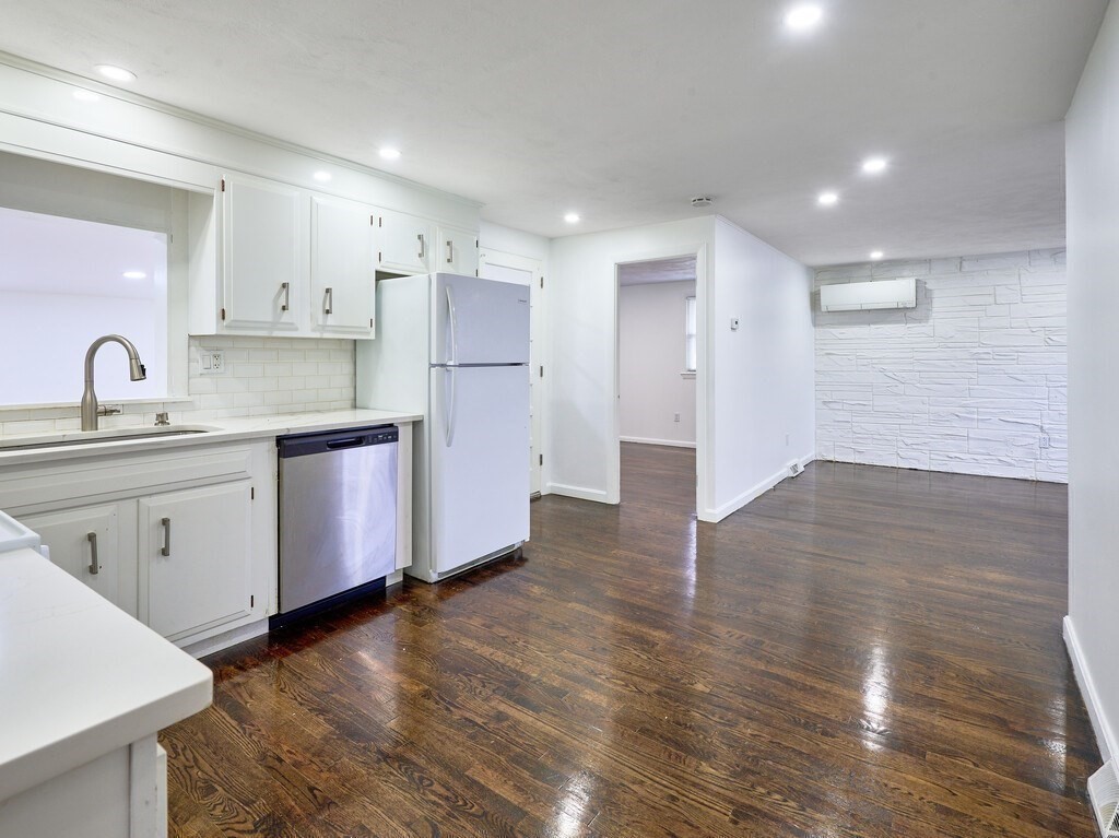 29 Dillon Street Worcester, MA 01604 - Photo 12 of 22 a kitchen with stainless steel appliances granite countertop a sink a stove a refrigerator and cabinets