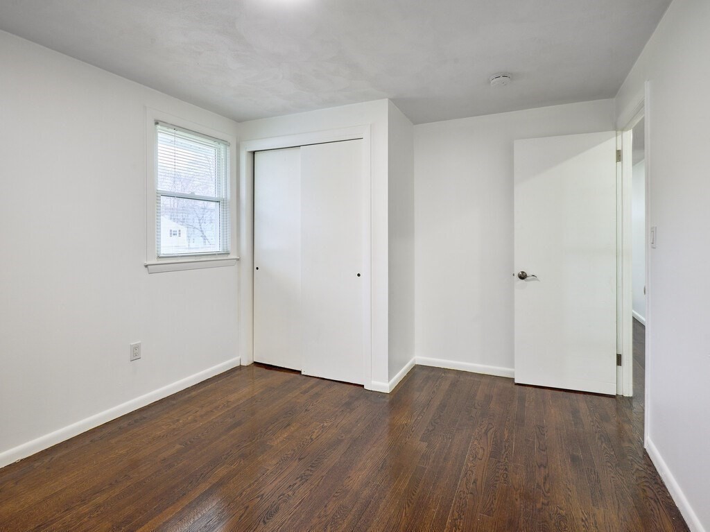 29 Dillon Street Worcester, MA 01604 - Photo 13 of 22 a view of room with wooden floor and window