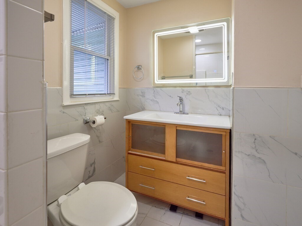 29 Dillon Street Worcester, MA 01604 - Photo 18 of 22 a bathroom with a toilet sink and mirror