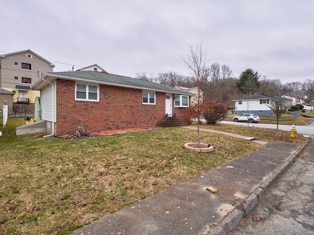 29 Dillon Street Worcester, MA 01604 - Photo 2 of 22 a front view of house with yard and trees in the background