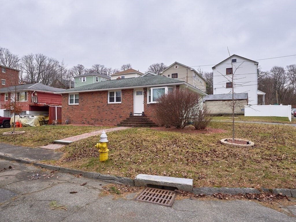 29 Dillon Street Worcester, MA 01604 - Photo 3 of 22 a front view of a house with a yard