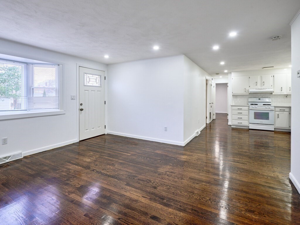 29 Dillon Street Worcester, MA 01604 - Photo 8 of 22 an empty room with wooden floor and windows