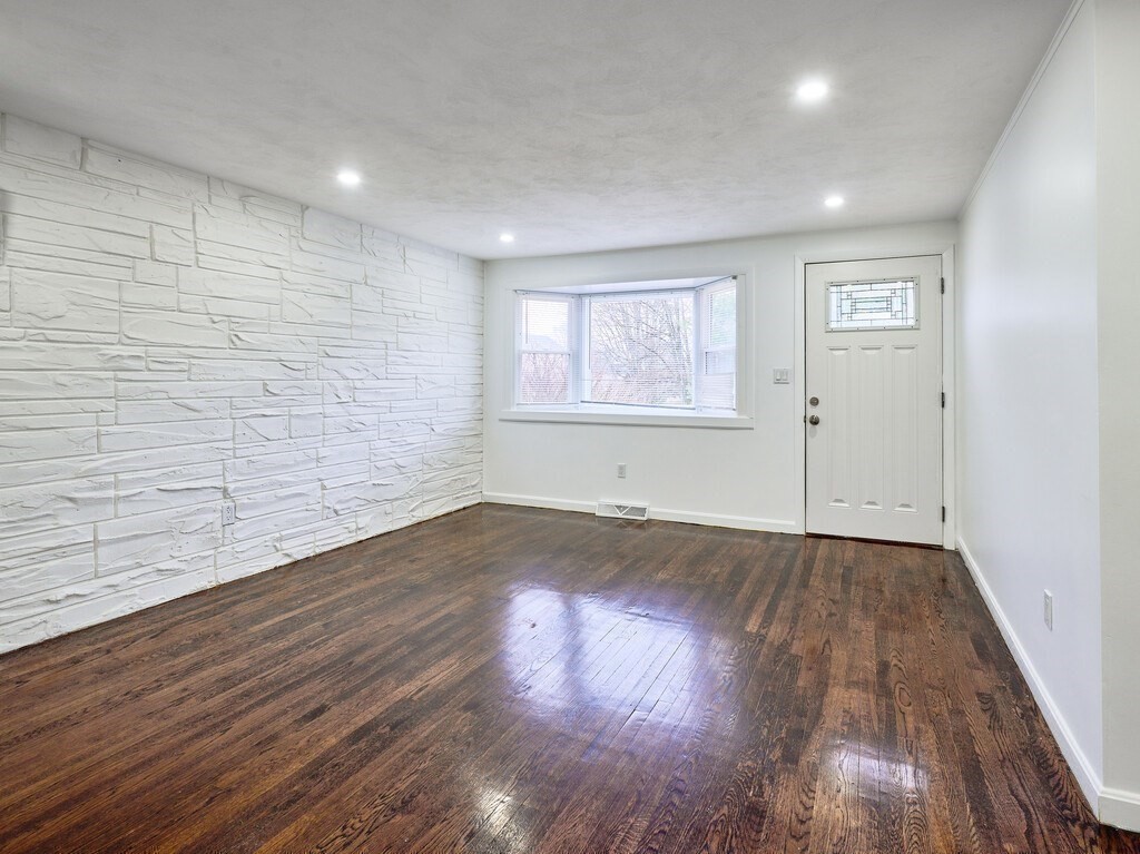 29 Dillon Street Worcester, MA 01604 - Photo 9 of 22 an empty room with wooden floor and windows
