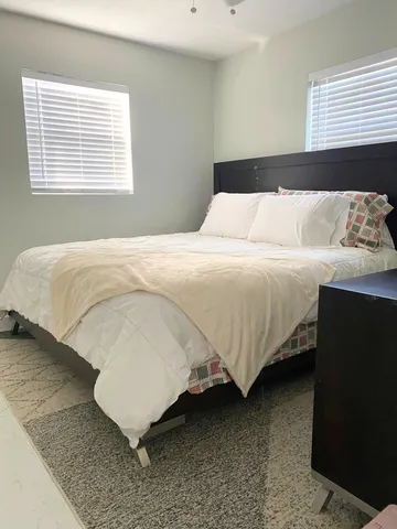 a bedroom with a bed and window