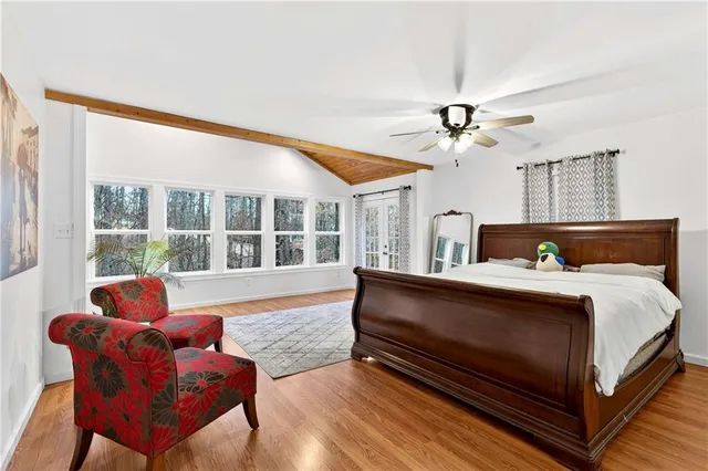 a bedroom with furniture and a large window