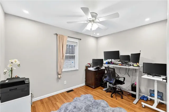 a view of a workspace with furniture and a window
