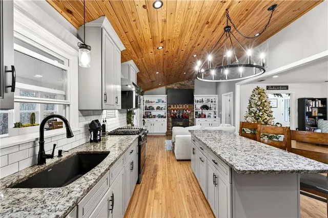 a kitchen with granite countertop a sink and stove
