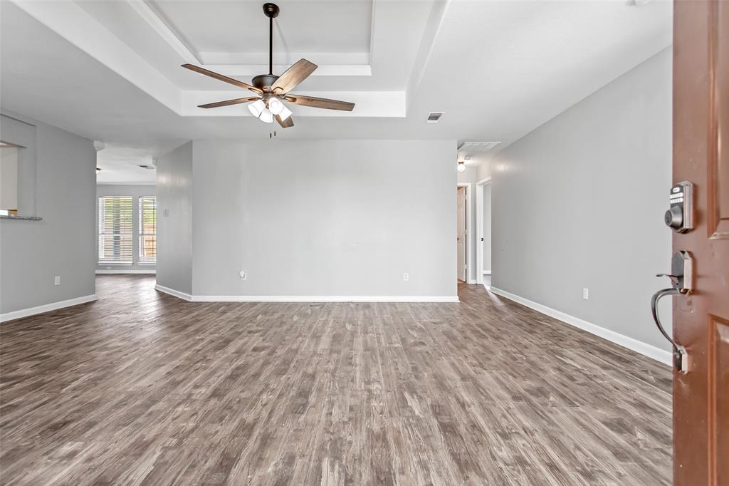 712 Billups Street Van Alstyne, TX 75495 - Photo 4 of 38 a view of a livingroom with a hardwood floor and a ceiling fan