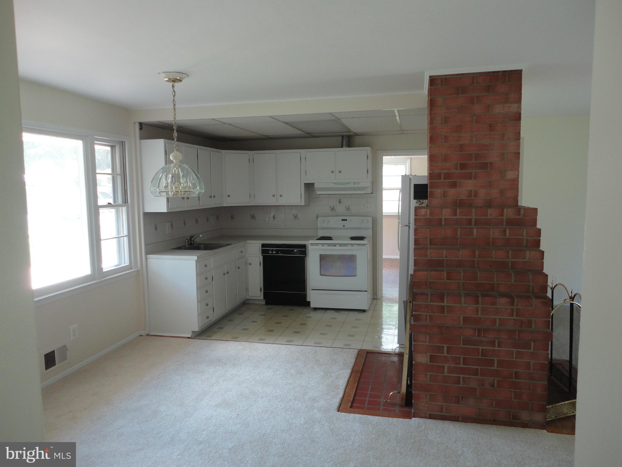 5512 Moultrie Road Springfield, VA 22151 - Photo 15 of 27 a kitchen with stainless steel appliances granite countertop a stove a sink and a refrigerator