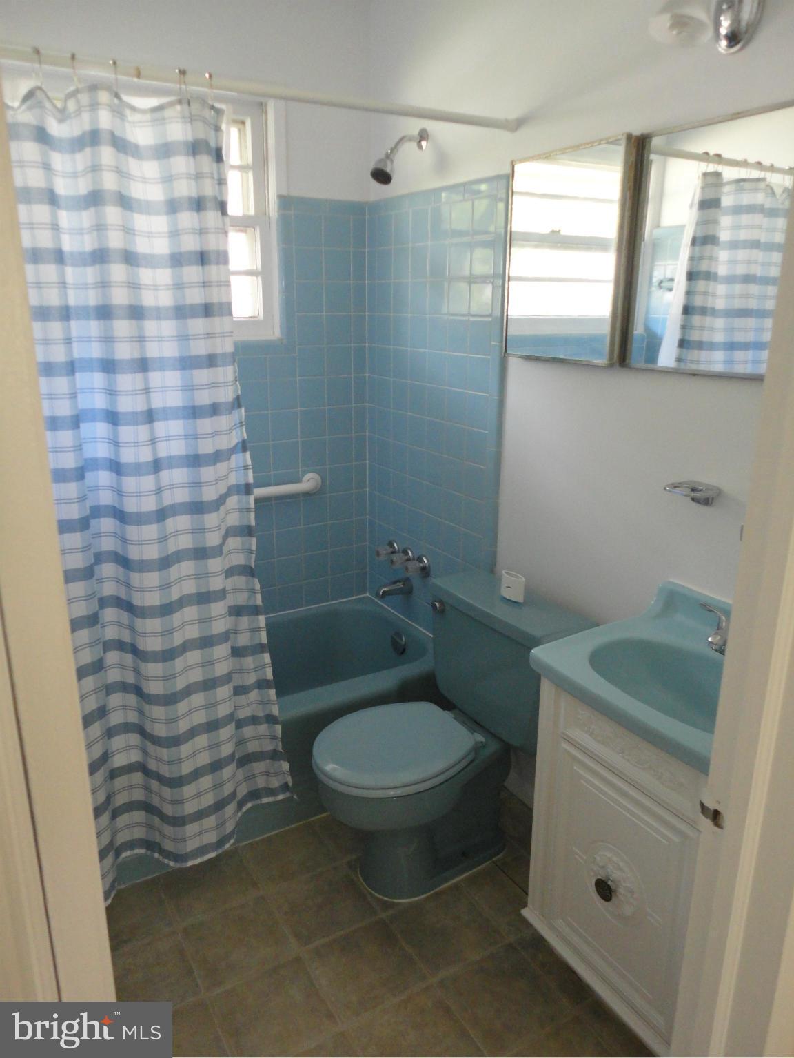5512 Moultrie Road Springfield, VA 22151 - Photo 21 of 27 a bathroom with a granite countertop toilet a sink and a shower