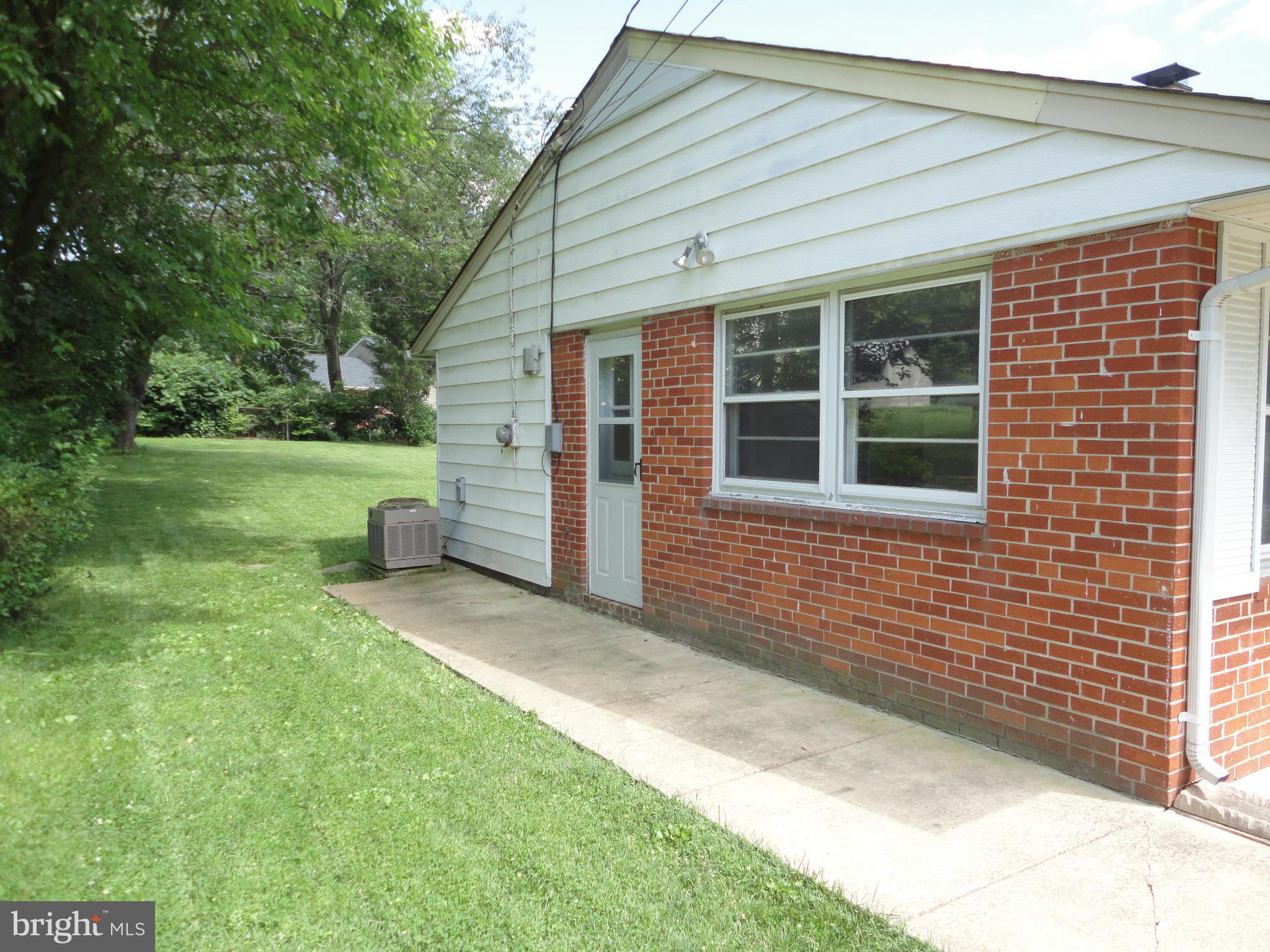 5512 Moultrie Road Springfield, VA 22151 - Photo 5 of 27 a view of a house with a backyard